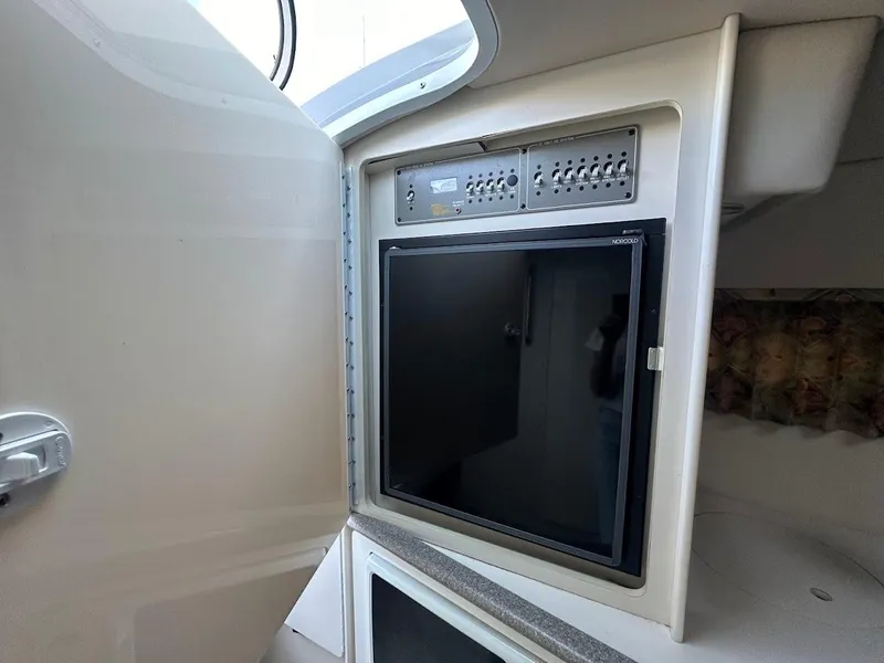 Slide: The Image of 1999 Formula 330 SS cabin interior with built-in refrigerator and control panel. - 36