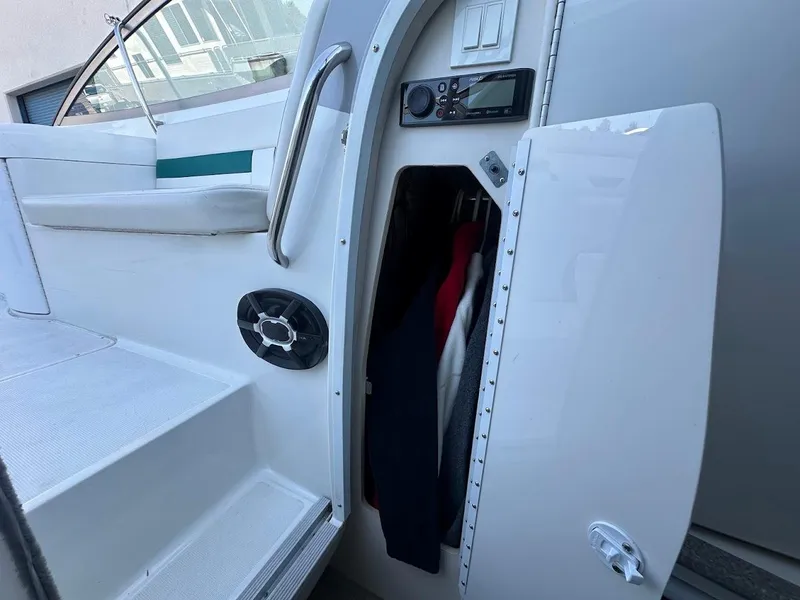 Slide: The Image of 1999 Formula 330 SS boat interior with open storage compartment and audio system. - 38