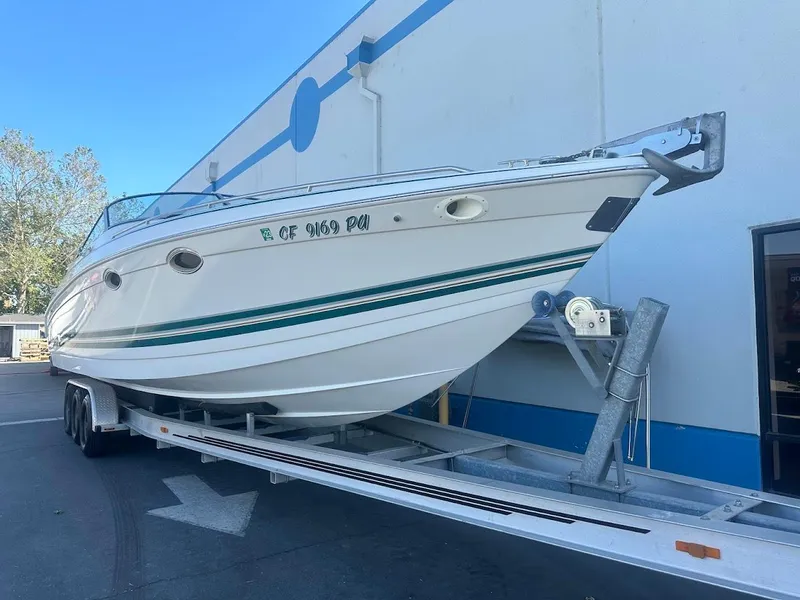 Slide: The Image of 1999 Formula 330 SS boat on trailer outside building. - 4
