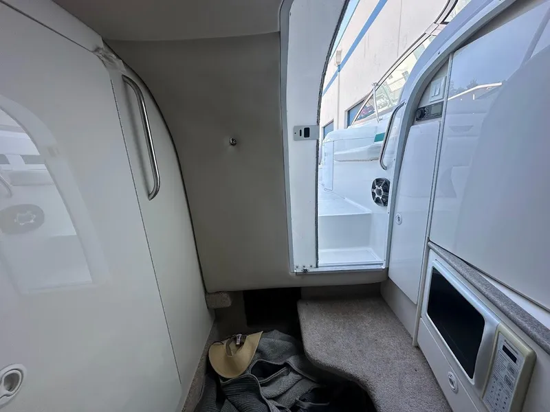 Slide: The Image of Interior cabin of a 1999 Formula 330 SS boat with microwave and storage. - 45