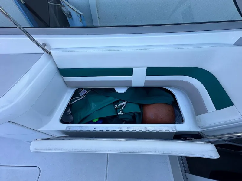 Slide: The Image of Storage compartment on a 1999 Formula 330 SS boat with green and white interior. - 47