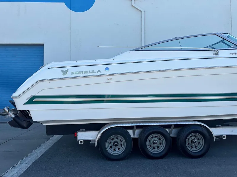 Slide: The Image of 1999 Formula 330 SS boat on a triple-axle trailer. - 6