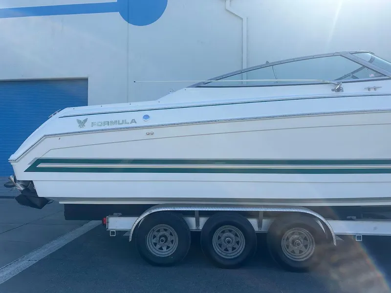 Slide: The Image of 1999 Formula 330 SS boat on a triple-axle trailer, side view. - 7