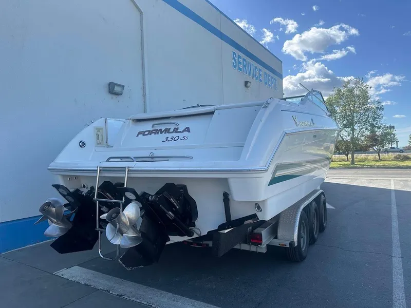 Slide: The Image of 1999 Formula 330 SS boat parked near a service department. - 8