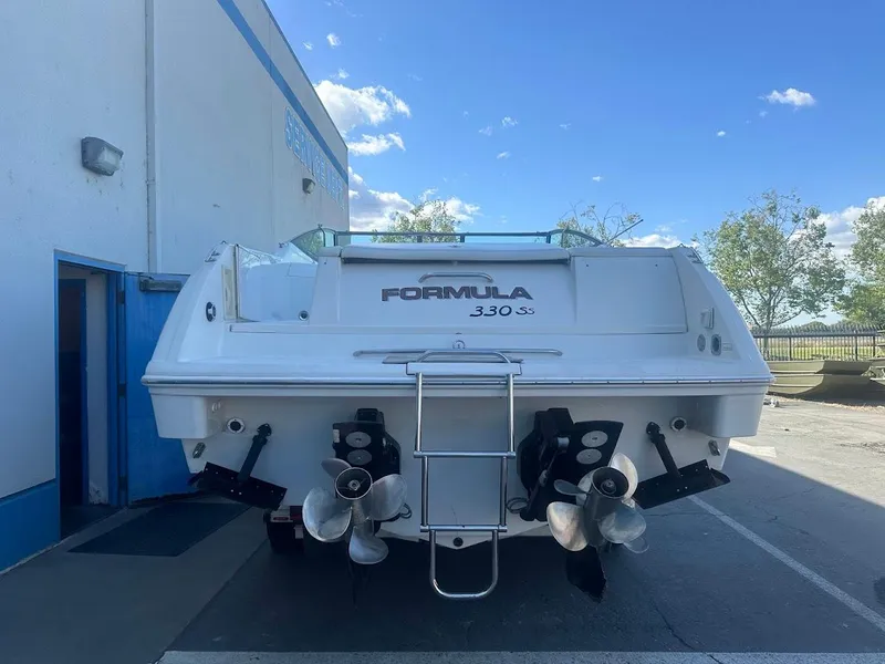 Slide: The Image of 1999 Formula 330 SS boat rear view with dual propellers. - 9