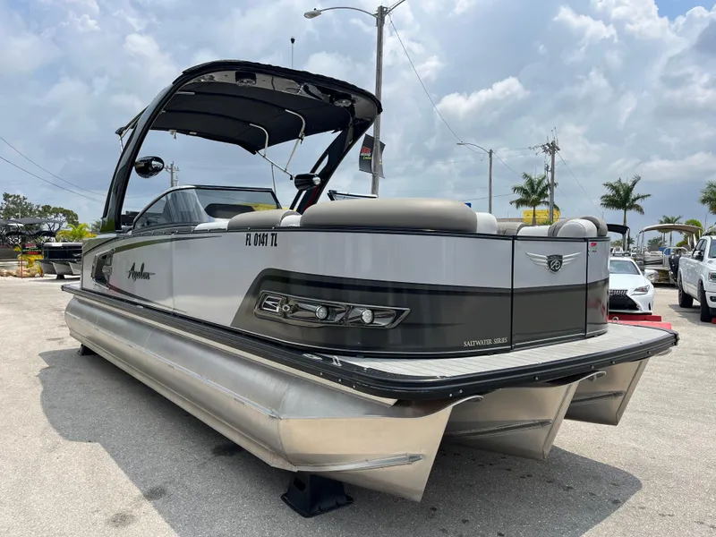 Slide: The Image of 2023 Avalon 2585 Excalibur LTD Tri Toon with Mercury Racing 400R, high-performance pontoon boat. - 2