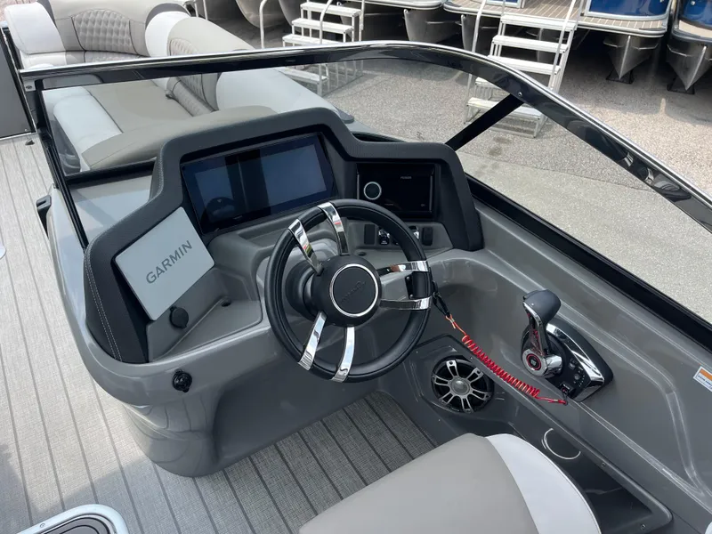 Slide: The Image of 2023 Avalon 2585 Excalibur LTD Tri Toon boat dashboard with Garmin navigation and Mercury Racing 400R controls. - 20