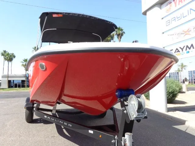 Slide: The Image of 2023 Bayliner Element M17 boat in red on a trailer, displayed outdoors. - 10