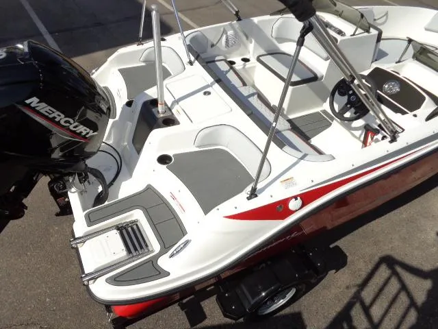 Slide: The Image of 2023 Bayliner Element M17 boat with Mercury outboard engine, white and red interior. - 14