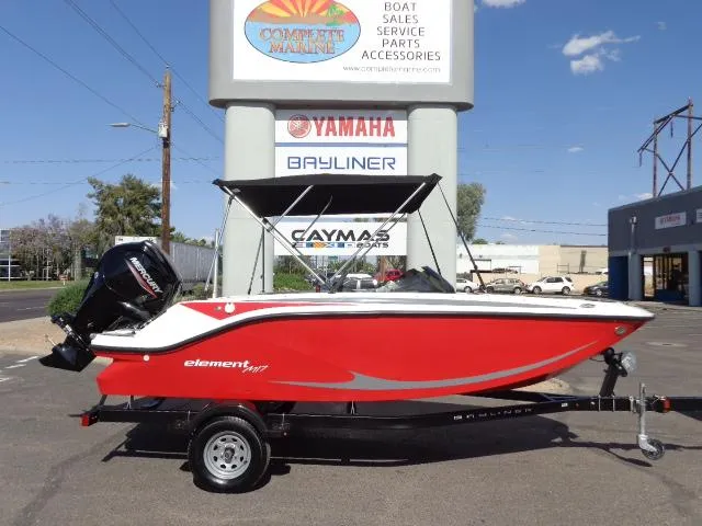 Slide: The Image of 2023 Bayliner Element M17 boat in red on a trailer at a dealership. - 18