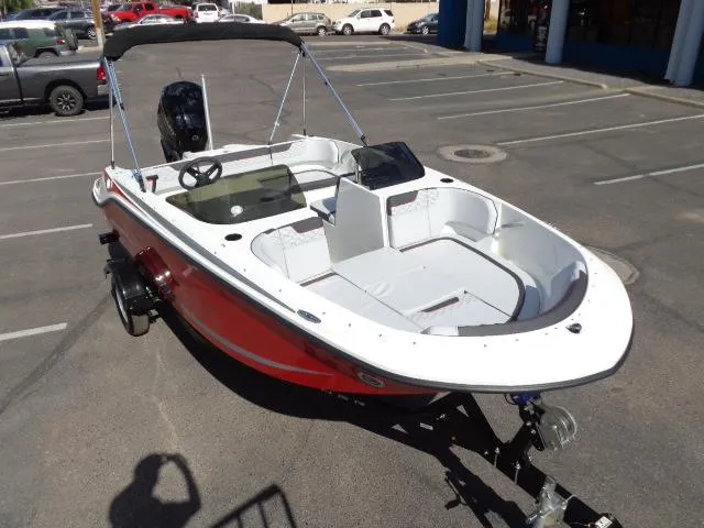 Slide: The Image of 2023 Bayliner Element M17 boat in parking lot, red and white exterior. - 5