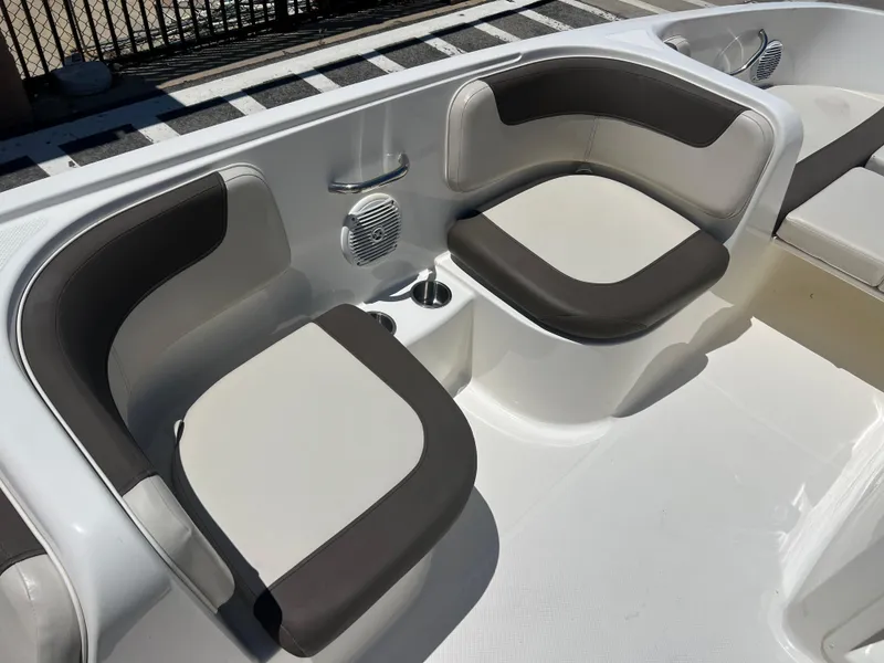 Slide: The Image of 2023 Bayliner Element E18 boat interior seating area with cup holder and speaker. - 11