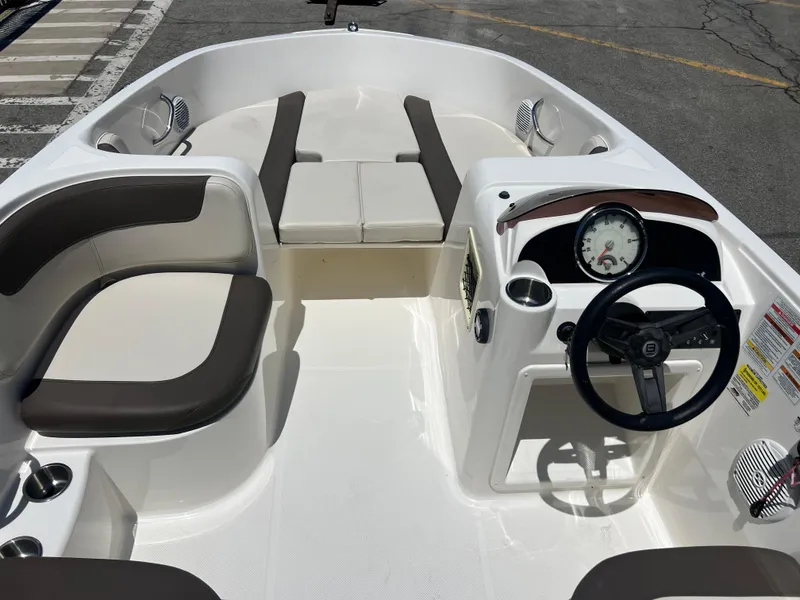 Slide: The Image of 2023 Bayliner Element E18 boat interior with seating and steering console. - 12
