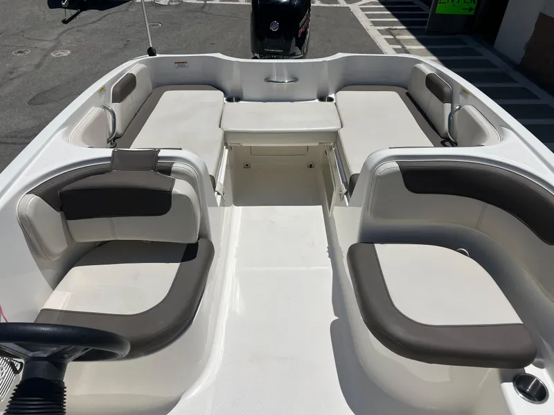 Slide: The Image of 2023 Bayliner Element E18 boat interior with spacious seating and modern design. - 15