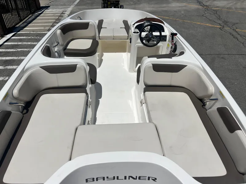Slide: The Image of 2023 Bayliner Element E18 boat interior with spacious seating and steering console. - 8