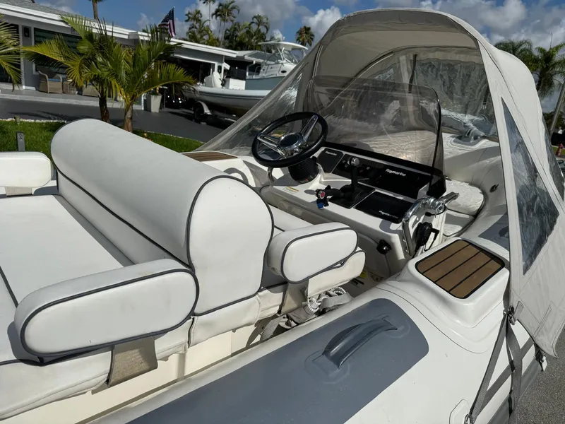Slide: The Image of 2019 Williams Jet Tenders 445 boat interior with white seating and steering console. - 14