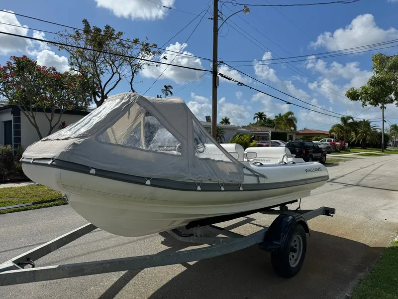 Slide: The Image of 2019 Williams Jet Tenders 445 boat on a trailer in a residential area. - 3