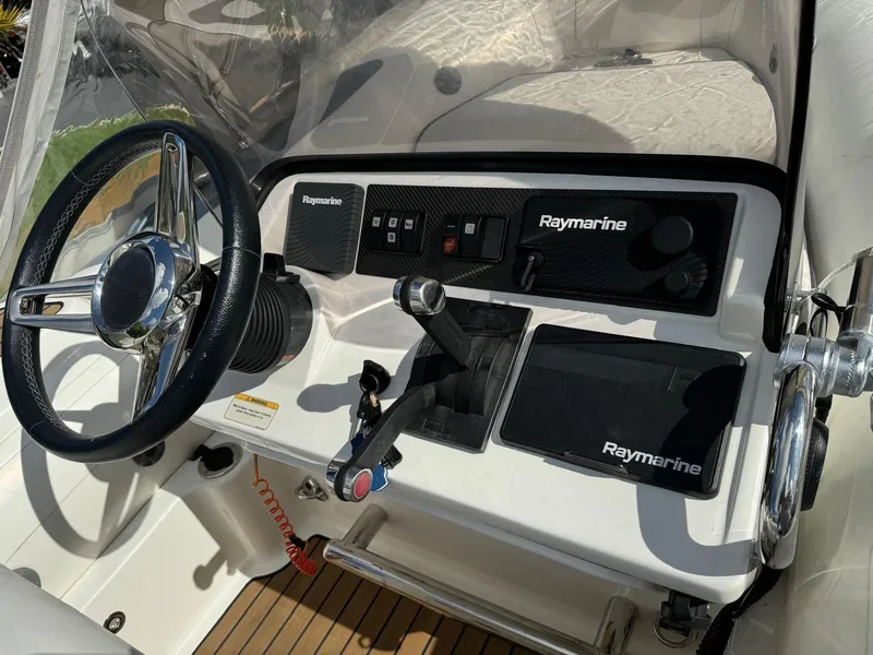 Slide: The Image of 2019 Williams Jet Tenders 445 dashboard with Raymarine electronics and steering wheel. - 8