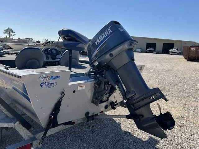 Slide: The Image of 2009 G3 Eagle 176 boat with Yamaha outboard motor in a gravel lot. - 7