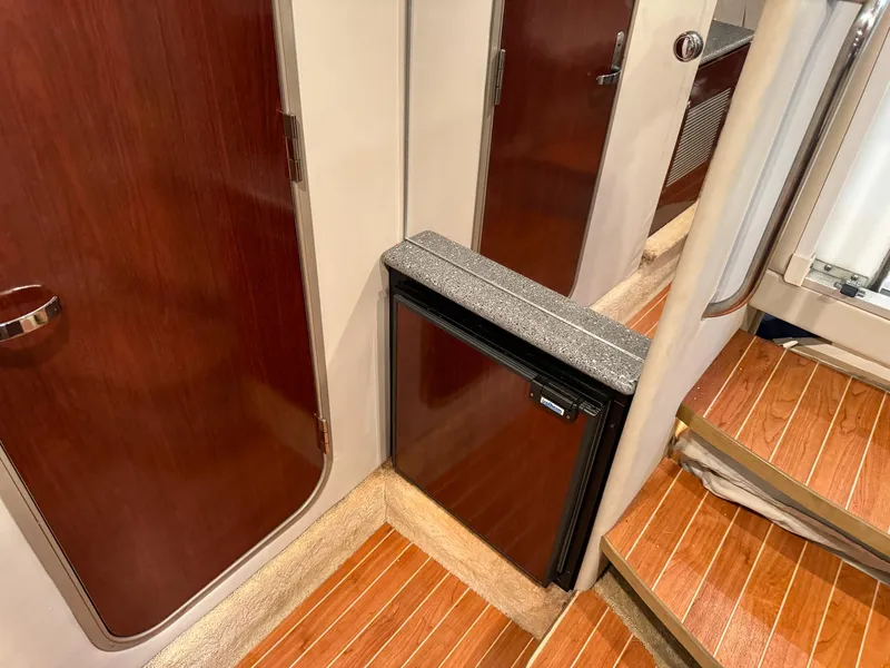 Slide: The Image of Interior of 2005 Formula 370 Super Sport with fridge and wooden flooring. - 18