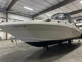 Slide: The Image of 2005 Sea Ray 320 Sundancer boat in indoor storage facility. - 10