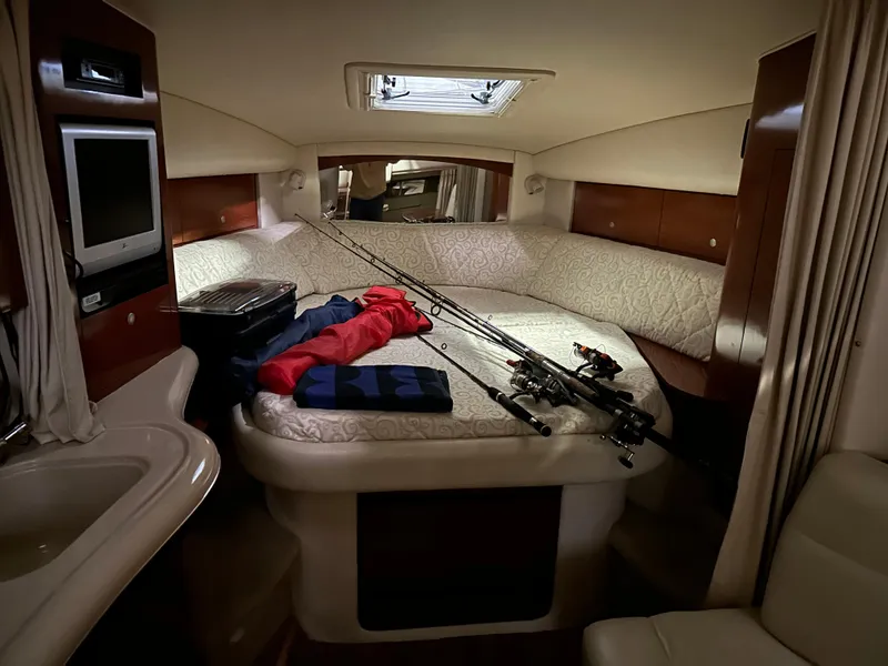 Slide: The Image of Interior cabin of a 2005 Sea Ray 320 Sundancer with fishing rods and gear. - 9