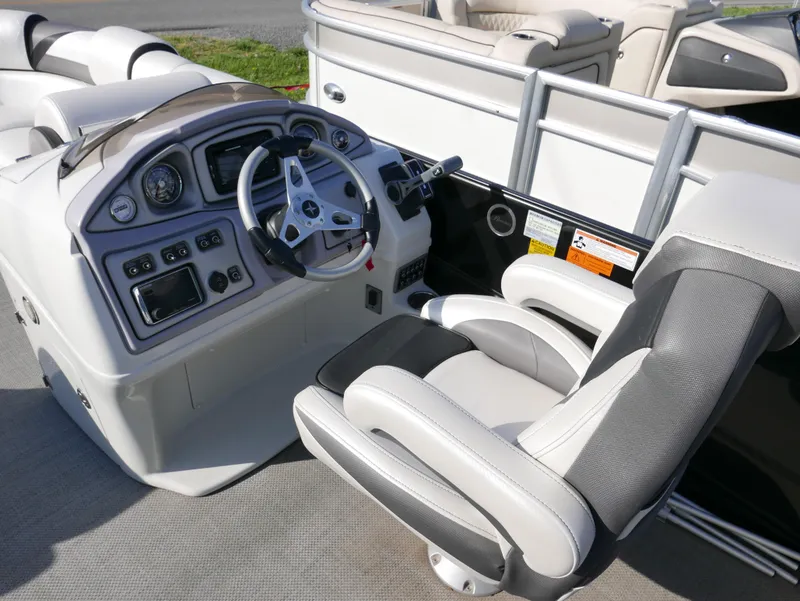 Slide: The Image of 2016 Berkshire 23RFX ARCH boat cockpit with steering wheel and control panel. - 7