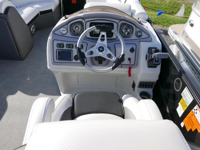 Slide: The Image of 2016 Berkshire 23RFX ARCH boat cockpit with steering wheel and control panel. - 8