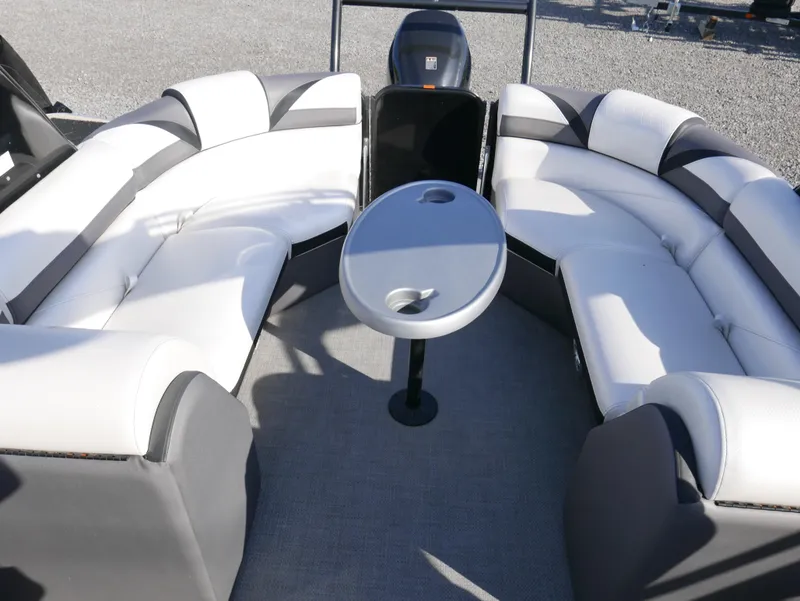 Slide: The Image of 2016 Berkshire 23RFX ARCH boat interior with white and gray seating and a central table. - 9