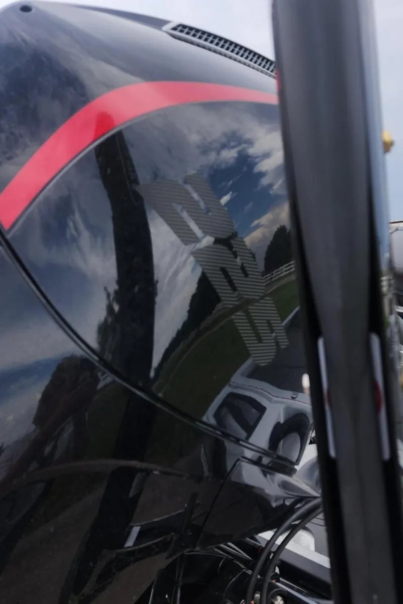 Slide: The Image of 2024 Ranger Z519 Garmin Ranger Cup Equipped boat engine close-up with reflection. - 12