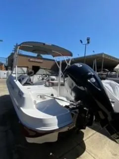 Slide: The Image of 2024 Tahoe 185 S boat with outboard motor in a sunny marina. - 3