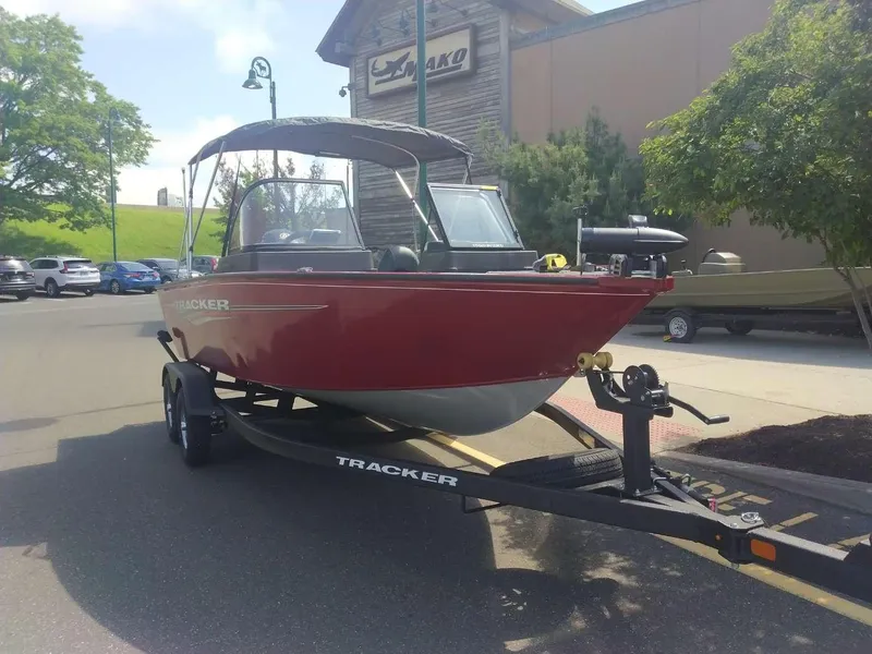 Slide: The Image of 2024 Tracker Pro Guide V-175 WT boat on trailer in parking lot. - 2