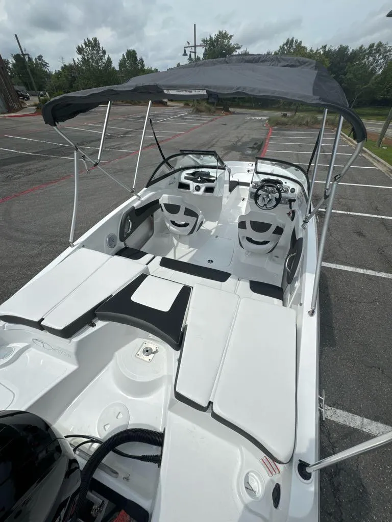 Slide: The Image of 2024 Tahoe 200 S boat with canopy in parking lot. - 4