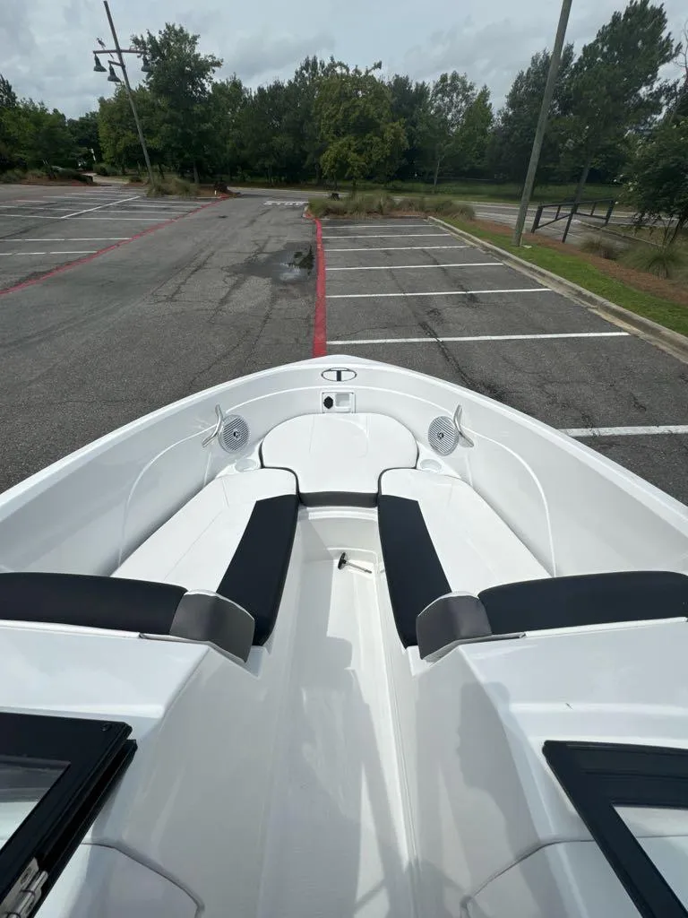 Slide: The Image of 2024 Tahoe 200 S boat with black and white seating in a parking lot. - 5