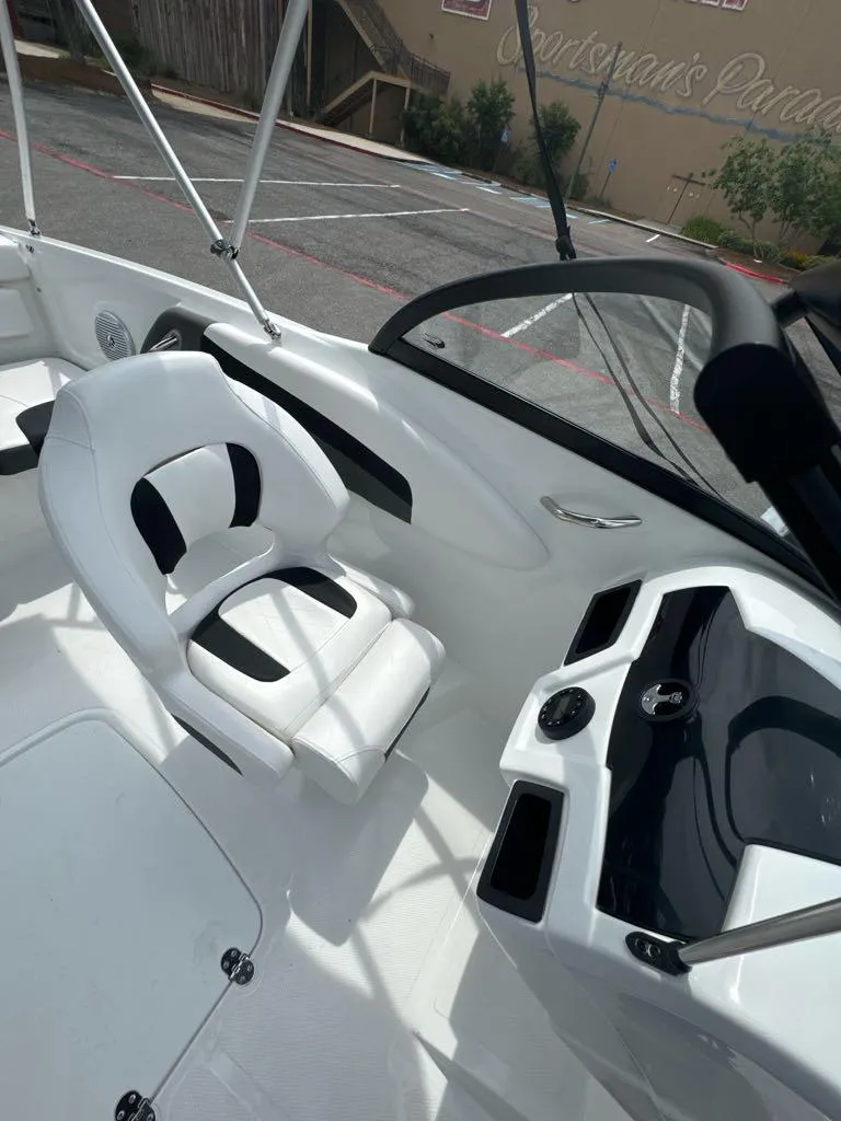 Slide: The Image of 2024 Tahoe 200 S boat interior with white captain's chair and sleek dashboard. - 6