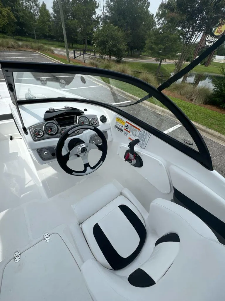 Slide: The Image of 2024 Tahoe 200 S boat interior with steering wheel and dashboard. - 7