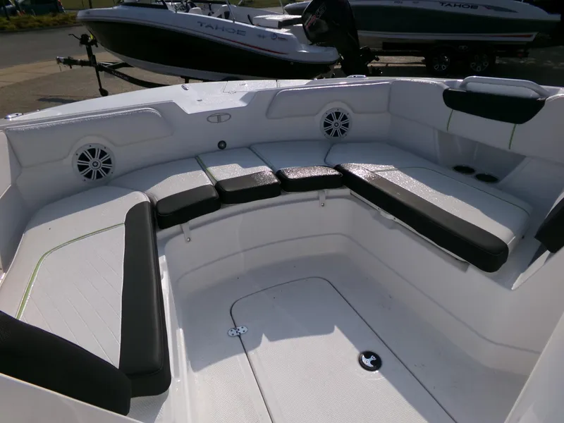 Slide: The Image of 2024 Tahoe 2150 CC boat interior with cushioned seating and speakers. - 3
