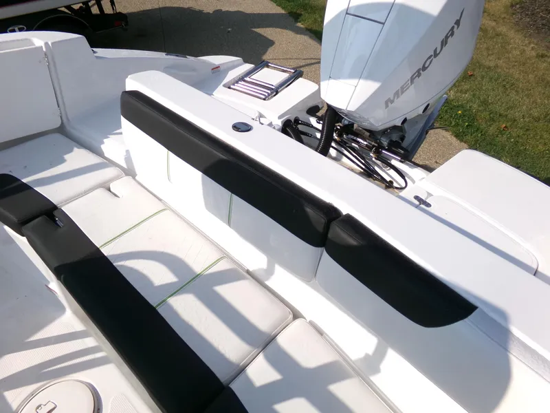 Slide: The Image of 2024 Tahoe 2150 CC boat interior with Mercury engine, featuring white and black seating. - 5