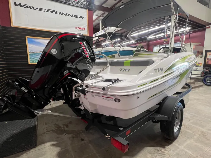 Slide: The Image of 2024 Tahoe T18 boat with outboard motor in showroom. - 2