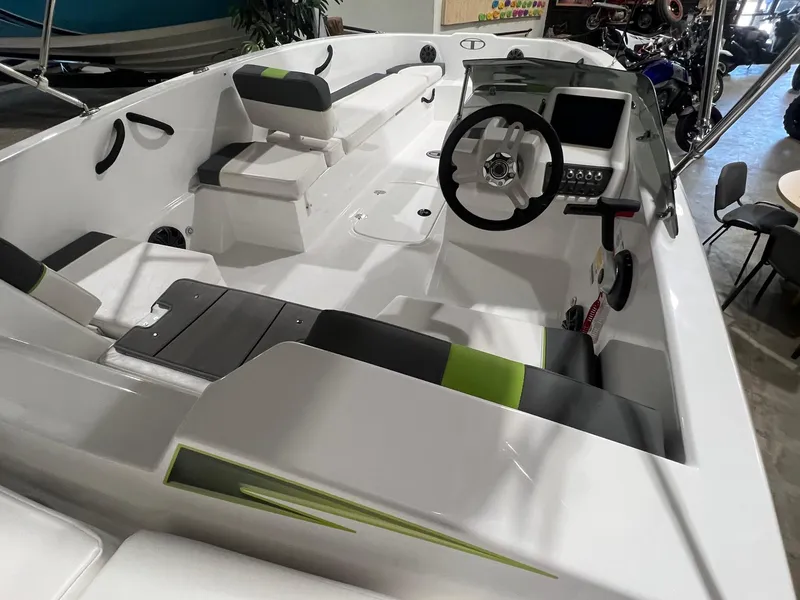 Slide: The Image of 2024 Tahoe T18 boat interior with modern seating and steering console. - 5