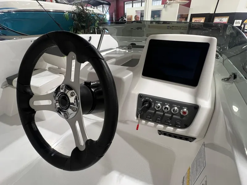 Slide: The Image of 2024 Tahoe T18 boat dashboard with steering wheel and control panel. - 6