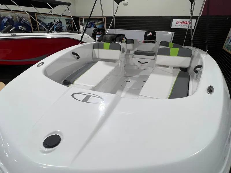 Slide: The Image of 2024 Tahoe T18 boat interior with white and green seating, displayed indoors. - 7