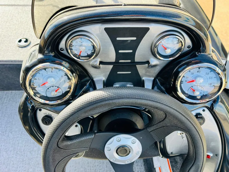 Slide: The Image of 2024 Tracker Pro Team 175 TF boat dashboard with steering wheel and gauges. - 21