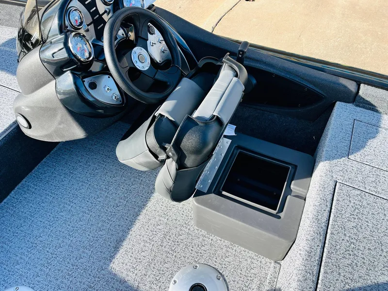Slide: The Image of 2024 Tracker Pro Team 175 TF boat cockpit with steering wheel and storage compartment. - 23