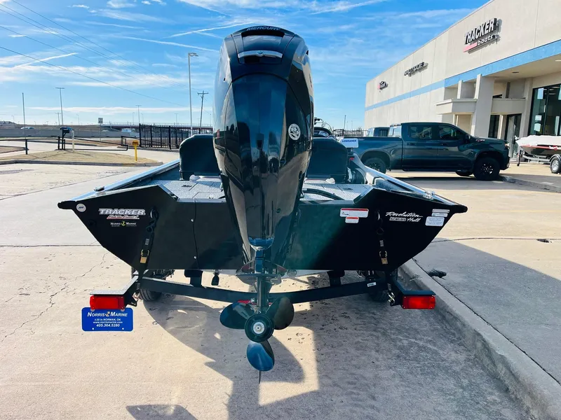 Slide: The Image of 2024 Tracker Pro Team 175 TF boat rear view at dealership. - 6