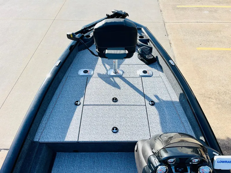 Slide: The Image of 2024 Tracker Pro Team 175 TF fishing boat deck with seating and storage compartments. - 9