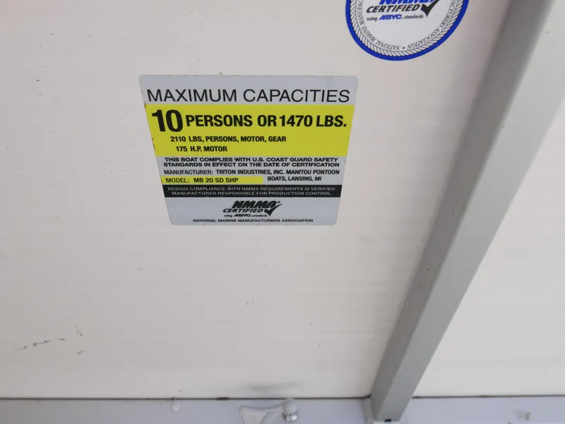 Slide: The Image of 2008 Manitou Oasis boat capacity label: 10 persons or 1470 lbs, 2100 lbs with motor and gear. - 12