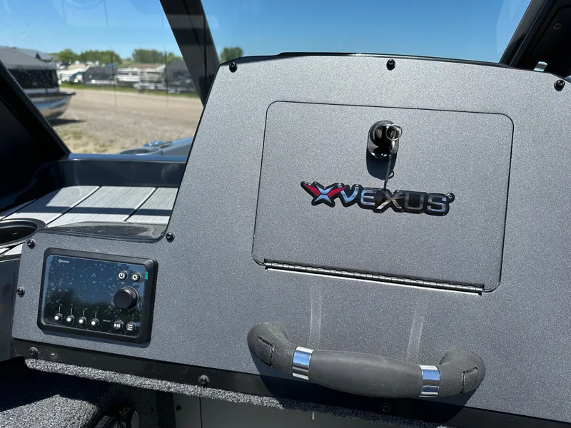 Slide: The Image of 2024 Vexus ADX180 boat dashboard with control panel and storage compartment. - 12