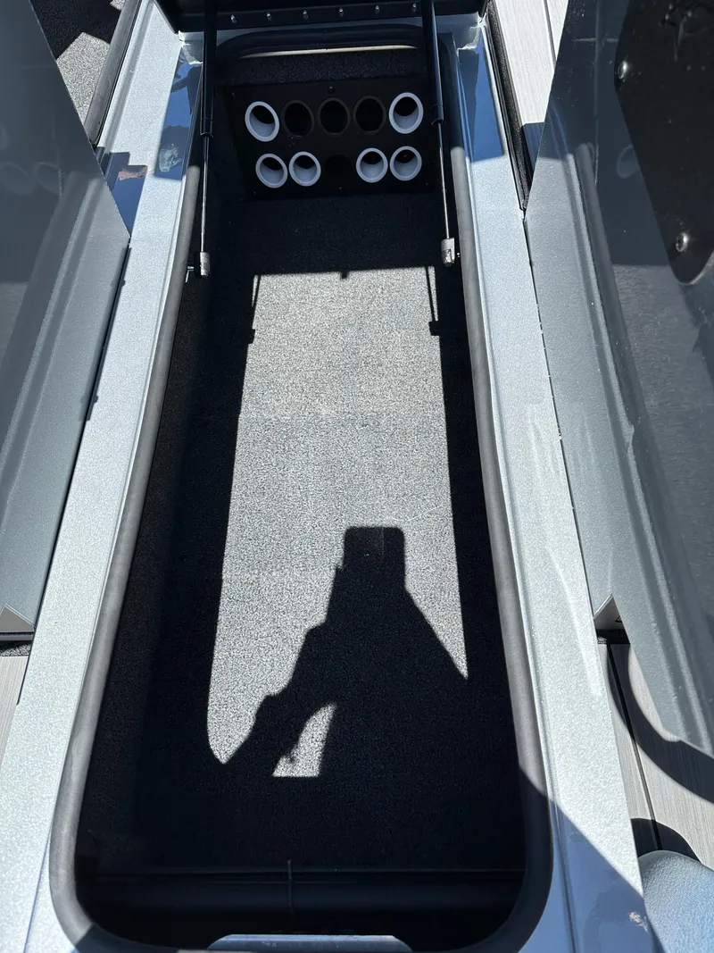 Slide: The Image of 2024 Vexus ADX180 boat storage compartment with rod holders. - 13