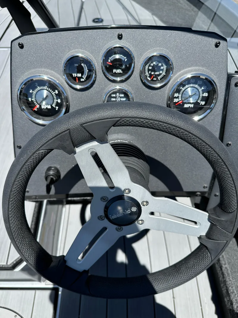 Slide: The Image of Steering wheel and dashboard of 2024 Vexus ADX180 boat with gauges. - 16